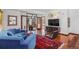 Spacious living room with hardwood floors, contemporary decor, and comfortable seating, with a view of the foyer at 6767 Timbers Dr, Evergreen, CO 80439