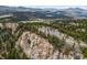 Panoramic mountain view with snow-capped peaks, forests, and rock outcroppings at 6767 Timbers Dr, Evergreen, CO 80439