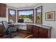 Bright office space with granite countertops, dark cabinetry, and stunning views of surrounding landscape through windows at 6767 Timbers Dr, Evergreen, CO 80439