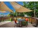 Inviting back deck with shade, outdoor seating, and green surroundings provides a comfortable space at 6255 Collegiate Dr, Highlands Ranch, CO 80130