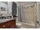 Modern bathroom featuring a granite countertop, updated fixtures, and a shower-tub combo at 6255 Collegiate Dr, Highlands Ranch, CO 80130