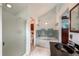Bathroom featuring jacuzzi tub, glass enclosed shower, and modern vanity at 6255 Collegiate Dr, Highlands Ranch, CO 80130