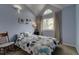 Bright bedroom featuring a high vaulted ceiling with a large arched window at 6255 Collegiate Dr, Highlands Ranch, CO 80130