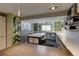 Bright bonus room with craft tables, shelving, and mountain wall decor, perfect for creative projects at 6255 Collegiate Dr, Highlands Ranch, CO 80130