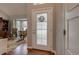 Bright foyer features a decorative glass door, hardwood floors, and a glimpse into a cozy seating area at 6255 Collegiate Dr, Highlands Ranch, CO 80130