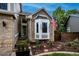Charming home exterior with brick facade, bay window, American flag, landscaping and walkway at 6255 Collegiate Dr, Highlands Ranch, CO 80130