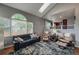 Open-concept living room with skylight and high ceilings offers a modern living experience at 6255 Collegiate Dr, Highlands Ranch, CO 80130