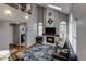 Living room with high ceilings, fireplace, skylight, large windows, and a hardwood floor at 6255 Collegiate Dr, Highlands Ranch, CO 80130