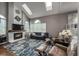 Living room featuring high ceilings, skylights, a fireplace, and a hardwood floor at 6255 Collegiate Dr, Highlands Ranch, CO 80130