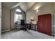 Office with vaulted ceiling, large arched window and a red storage cabinet at 6255 Collegiate Dr, Highlands Ranch, CO 80130