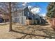 Side view of townhomes with fenced yards, trees and shadows at 1055 Milo Cir # A, Lafayette, CO 80026