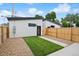 A modern white detached garage with a small backyard and wooden fence at 2391 King St, Denver, CO 80211