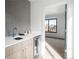 Stylish bar area features a mosaic tile backsplash, sleek cabinets, and a wine fridge at 2391 King St, Denver, CO 80211