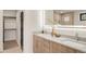 Elegant bathroom with dual sinks, modern vanity, and a spacious walk-in closet at 2391 King St, Denver, CO 80211