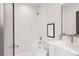 Clean bathroom with modern finishes, white subway tile, framed art, and sleek fixtures at 2391 King St, Denver, CO 80211