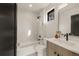 Modern bathroom featuring a bathtub, glass-enclosed shower, and stylish vanity with sleek fixtures at 2391 King St, Denver, CO 80211