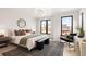 Bright bedroom features a neutral palette, large windows, sleek furnishings, and ample natural light at 2391 King St, Denver, CO 80211