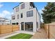 Back exterior of modern home with a spacious green yard and privacy fence at 2391 King St, Denver, CO 80211