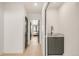 Hallway with wood floors, dark door frames, sink with modern fixtures, and view of bedroom at 2391 King St, Denver, CO 80211