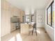 Bright, open kitchen featuring an island with seating, modern appliances, and ample cabinet space at 2391 King St, Denver, CO 80211