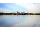 Scenic view of Denver skyline across a serene lake surrounded by lush greenery at 2391 King St, Denver, CO 80211