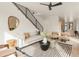 A stylish living room features a modern staircase, elegant decor and sunlit atmosphere at 2391 King St, Denver, CO 80211