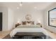 A well-lit main bedroom showcasing a large bed, stylish decor, and a relaxing ambiance at 2391 King St, Denver, CO 80211