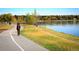 Picturesque paved path by a tranquil lake, ideal for walking and enjoying scenic views at 2391 King St, Denver, CO 80211