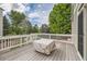 Spacious back deck is surrounded by lush trees in the backyard at 8469 Winter Berry Dr, Castle Pines, CO 80108