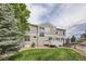 Well-maintained two-story home exterior and backyard with a deck and manicured lawn at 8469 Winter Berry Dr, Castle Pines, CO 80108