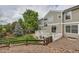 A two-story home's backyard with wooden deck, fencing, and a well-kept lawn at 8469 Winter Berry Dr, Castle Pines, CO 80108