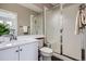 Bathroom with white vanity, quartz countertop, frosted glass shower doors, and neutral wall color at 8469 Winter Berry Dr, Castle Pines, CO 80108