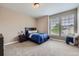 Bright bedroom featuring neutral walls, plush carpet, and natural light from two windows at 8469 Winter Berry Dr, Castle Pines, CO 80108
