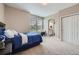 Cozy bedroom with neutral walls, carpet, large window and adjoining bathroom at 8469 Winter Berry Dr, Castle Pines, CO 80108