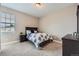 A well-lit bedroom with soft carpet, neutral walls, and a dark wooden frame bed at 8469 Winter Berry Dr, Castle Pines, CO 80108