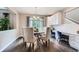 Bright dining area featuring a chandelier and a desk with cabinets and quartz countertops at 8469 Winter Berry Dr, Castle Pines, CO 80108