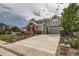 Beautiful two story home with brick and siding, attached two car garage and driveway at 8469 Winter Berry Dr, Castle Pines, CO 80108