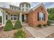 Charming front entrance with well-kept landscaping and a cozy, welcoming porch at 8469 Winter Berry Dr, Castle Pines, CO 80108