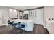 Bright kitchen featuring stainless appliances, quartz countertops, island, barstool seating and cabinets at 8469 Winter Berry Dr, Castle Pines, CO 80108
