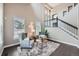 Bright living room featuring a staircase, two armchairs, a shag rug and large windows at 8469 Winter Berry Dr, Castle Pines, CO 80108