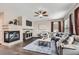 Bright living room featuring a fireplace, hardwood floors, a large couch and many windows at 8469 Winter Berry Dr, Castle Pines, CO 80108