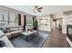 Bright living room featuring hardwood floors, a large couch and many windows at 8469 Winter Berry Dr, Castle Pines, CO 80108