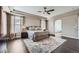 Main bedroom with tray ceiling, elegant decor, and ensuite bath visible through archway at 8469 Winter Berry Dr, Castle Pines, CO 80108