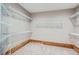 Walk-in closet with custom shelving, carpet, and trim at 8469 Winter Berry Dr, Castle Pines, CO 80108