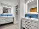 Contemporary bathroom featuring double vanities with illuminated mirrors and sleek modern fixtures at 1374 Crested Butte Ct, Evergreen, CO 80439