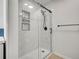 Modern bathroom featuring a glass shower with marble tile surround and black hardware at 1374 Crested Butte Ct, Evergreen, CO 80439