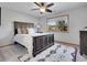 Comfortable bedroom featuring a large window with a view, plush carpet, and a stylish area rug at 1374 Crested Butte Ct, Evergreen, CO 80439