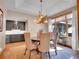 Inviting dining room with unique antler chandelier, table with upholstered chairs, and a view from the large window at 1374 Crested Butte Ct, Evergreen, CO 80439