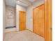 Welcoming entryway with tile flooring, a built-in bench, and modern decor at 1374 Crested Butte Ct, Evergreen, CO 80439