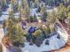 An upscale home surrounded by mature trees, offering seclusion and a picturesque setting in a wooded area at 1374 Crested Butte Ct, Evergreen, CO 80439